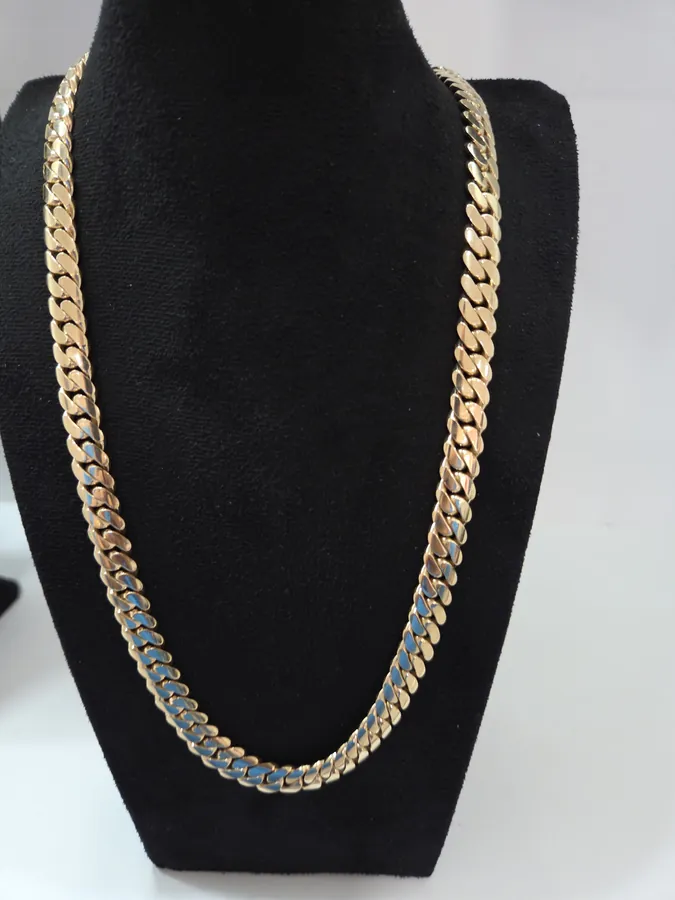 Cuban link chain in 10K gold on black velvet